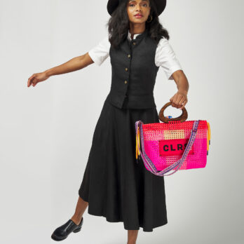 Woman in motion holding a bold pink CLRS by SAAT tote – fashion meets function.