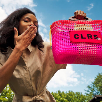 Woman holding a pink CLRS by SAAT bag up to the sky – playful, joyful, and full of colour.